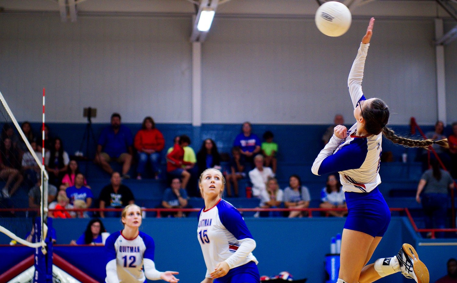 Emilee Baker swats a ball back to the Lady Devilis from midcourt. [view more volleyball shots]